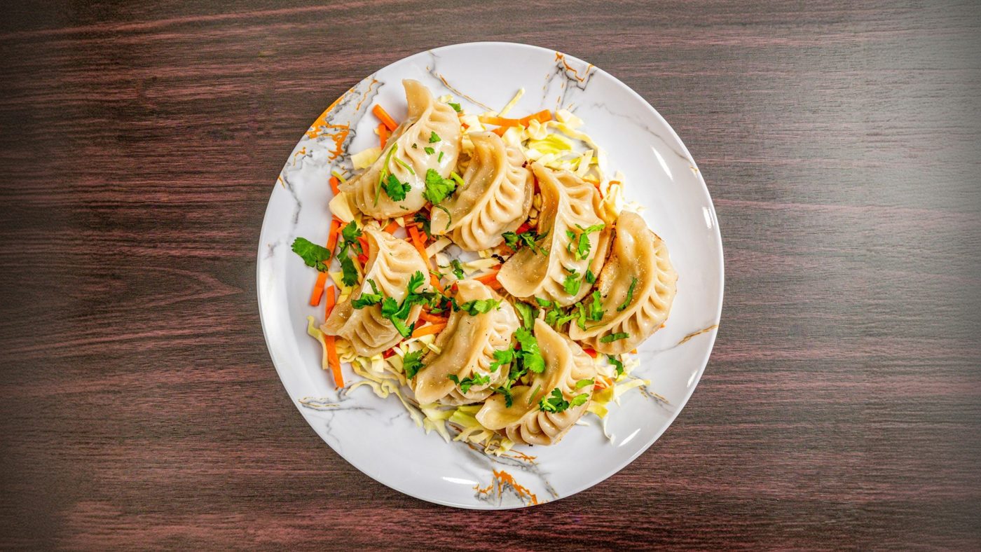 Steamed momos with tomato achar